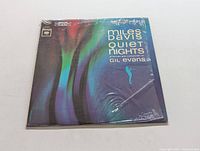 Front cover of shrink-wrapped Miles Davis 'Quiet Nights' LP album showing colorful artwork and album title.