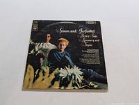 Front cover of the Simon & Garfunkel LP 'Parsley, Sage, Rosemary and Thyme' showing the artists and floral decoration.