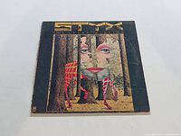 Front cover of Styx 'The Grand Illusion' vinyl LP showing surreal artwork.