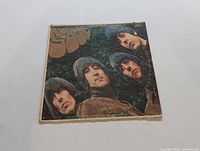 Front album cover showing The Beatles headshots and 'Rubber Soul' title in orange lettering.