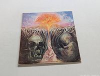 Front cover of The Moody Blues LP "In Search for the Lost Chord" showing psychedelic artwork with skulls and surreal imagery.