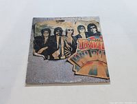 Front cover of The Traveling Wilburys Volume 1 LP showing band members image and album title.