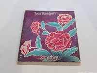 Vinyl LP sleeve for "Something" by Todd Rundgren with purple floral design.