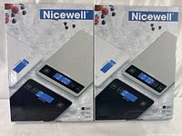 Two boxed, factory-sealed Nicewell digital food scales in original packaging showing front and side panels with product image and branding.