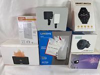 Full view of all 7 sealed electronics boxes grouped together showing the set contents