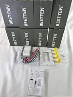 8 boxed new BESTTEN dimmable LED wall switches with one switch and associated components visible in front including wall plate, wire nuts, and instruction sheet.