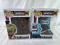 Front view of both Funko Pop! figures in original packaging showing Da Samurai and The Guardian from Samurai Jack.