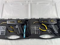 Two hot stapler welding torch kits laid open showing contents including torch, pliers, staples, and precision tool inside black carrying cases.