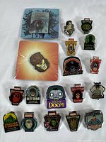 Top-down photo of all 18 pins showing a variety of Marvel characters including Thor, MODOK, Doctor Doom, Deadpool, Riddler, Swamp Thing, and others.