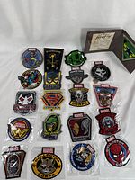 Full view of 20 colorful superhero patches from Marvel and DC, laid out in rows, featuring character faces, logos and 'Collector Corps' branding.