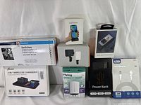 Photo showing all 8 sealed electronics items together on a white surface