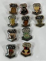 Full set of 10 Star Wars enamel pins on fabric background showing all characters and 'Star Wars' logo