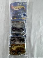 Full blister pack with four factory sealed vintage Hot Wheels cars visible through clear blister.