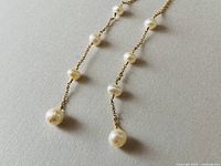 Close-up of the two pearl drop earrings showing the pearl spacing on gold filled chain.