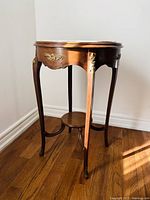 Full view of table showing marble top, carved hardwood base and curved legs