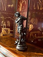 Full front view of bronze boy fishing statue