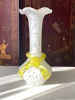 Front view of the Murano glass vase showing the white speckled pattern with yellow glass ribbon detail.