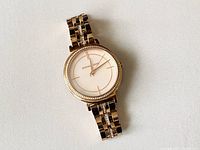 Front view of the Michael Kors women's wristwatch showing the mother of pearl dial, rose gold tone case and crystal bezel.