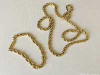 Overhead view of necklace and bracelet laid flat on light background
