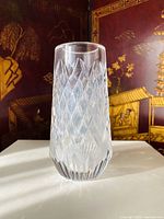 Front view of the tall crystal vase displaying diamond cut pattern with light reflections.