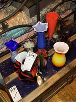 Overview of eight art glass vases displayed on a surface