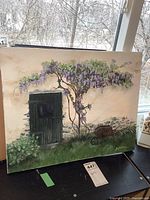 Front view of the full oil painting showing the green door, flowering tree, and wheelbarrow with basket on grass.