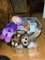 Overview of entire lot showing a plastic bag full of plush toys including the Cabbage Patch doll and multiple TY Beanie Babies with visible tags