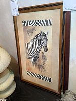 Framed signed zebra print artwork with zebra-striped mat frame borders