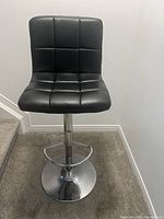 Front view showing full barstool, seat tufting, chrome base