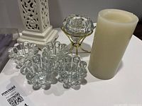 Group shot showing all candle holders, flameless candle, gold stand, ceramic holder