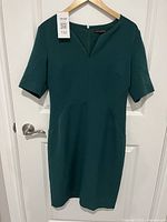 Front view of dark green Banana Republic dress on hanger