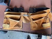 Front view showing twin suede pouches, hammer loop, buckle ends and rivet details