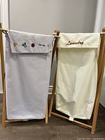 Front view of both wooden-frame linen hampers