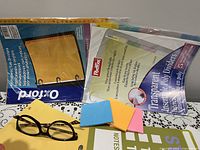 Group showing dividers, glasses, sticky notes, notepad