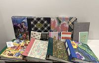 All 14 photo albums grouped on table showing size variety and cover designs