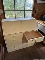 Desk closed showing drop-front and drawers
