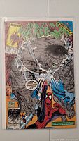 Front cover of The Amazing Spider-Man #328 comic book showing Spider-Man and a large gray monster, bagged and boarded