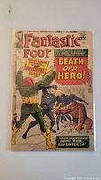 Full front cover of Fantastic Four #32 comic showing Moratt and Fantastic Four characters with prominent text "Death of a Hero!"