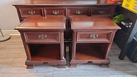 Two matching mahogany nightstands side by side in room