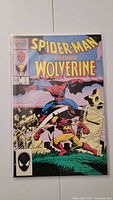 Full front cover of the comic showing Spiderman versus Wolverine in a fight scene with the title prominently displayed.