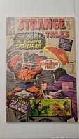 Front cover of Strange Tales #132 comic showing The Thing engaged in battle. Cover price is 12 cents. Protective plastic sleeve visible.