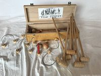 Full view of the wooden croquet set showing mallets, balls, wickets, stakes and open wooden box with Vilac label inside lid