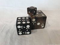 Three rosewood blocks with mother of pearl inlays showing various patterns from a front view