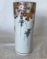 Front view of hand painted chrysanthemum porcelain vase showing flower details and gold-rimmed top edge.