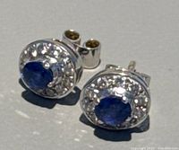 Pair of earrings on flat light background showing front design