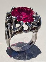 Front angle view of the ring displaying the large oval red semi-precious stone set in detailed 925 silver band.