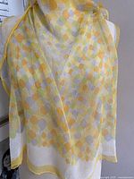 Scarf loosely draped hanging down showing pattern colors and fabric sheerness