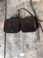 Top view of two Apple TV boxes side by side on work surface