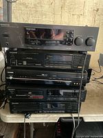 Stacked view of Kenwood receiver, Pioneer CD player, Toshiba DVD player, Sony cassette deck, cords visible