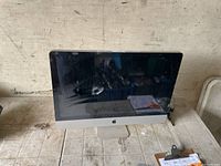 Front view of Apple iMac showing screen and aluminum stand